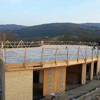 Cement bonded particle board roof on X-lam